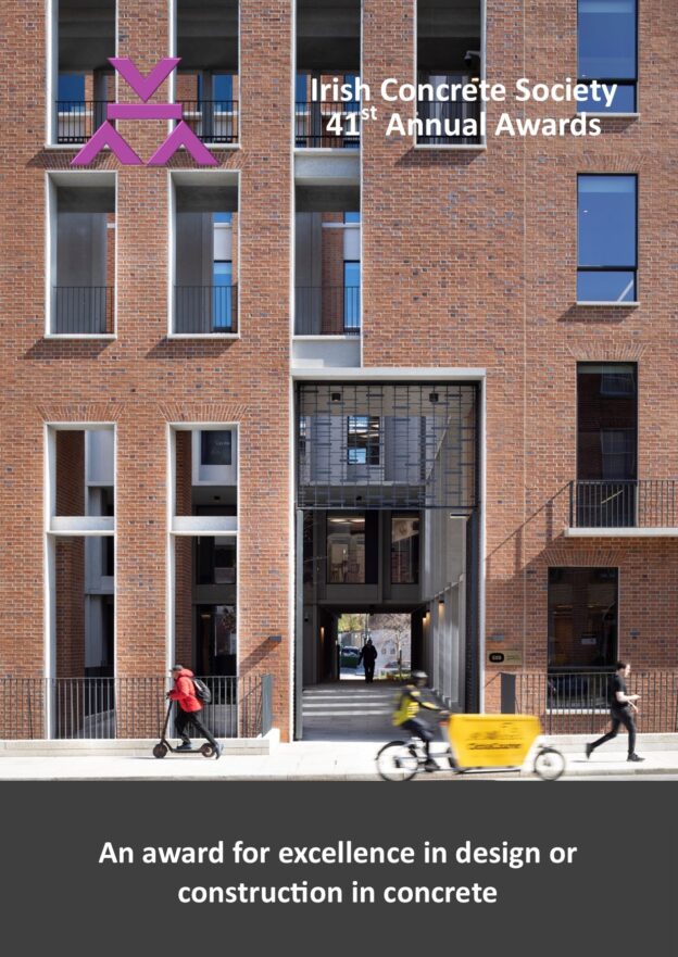 Front façade of the Project Fitzwilliam building with a man in a red jacket on a scooter, a 2nd man on a a yellow cargo bike and a 3rd man in black walking past.